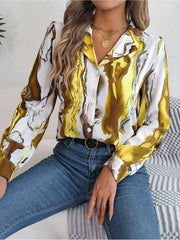 Women's abstract swirl print silk blouse in yellow and white with button front and collar.