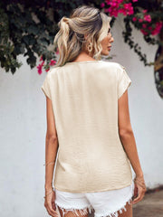 Beige Flutter V Blouse with textured fabric and cap sleeves.