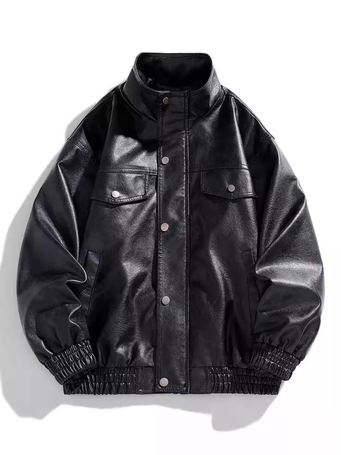 Black oversized faux leather bomber jacket with snap buttons and chest pockets.