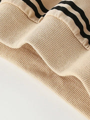 Tan cotton crew neck sweatshirt with black stripes and ribbed details.