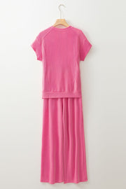 Fuchsia pink ribbed knit drawstring co-ord set with short sleeves and wide-leg pants.