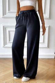 Dark blue textured rib wide-leg drawstring trousers with pockets.