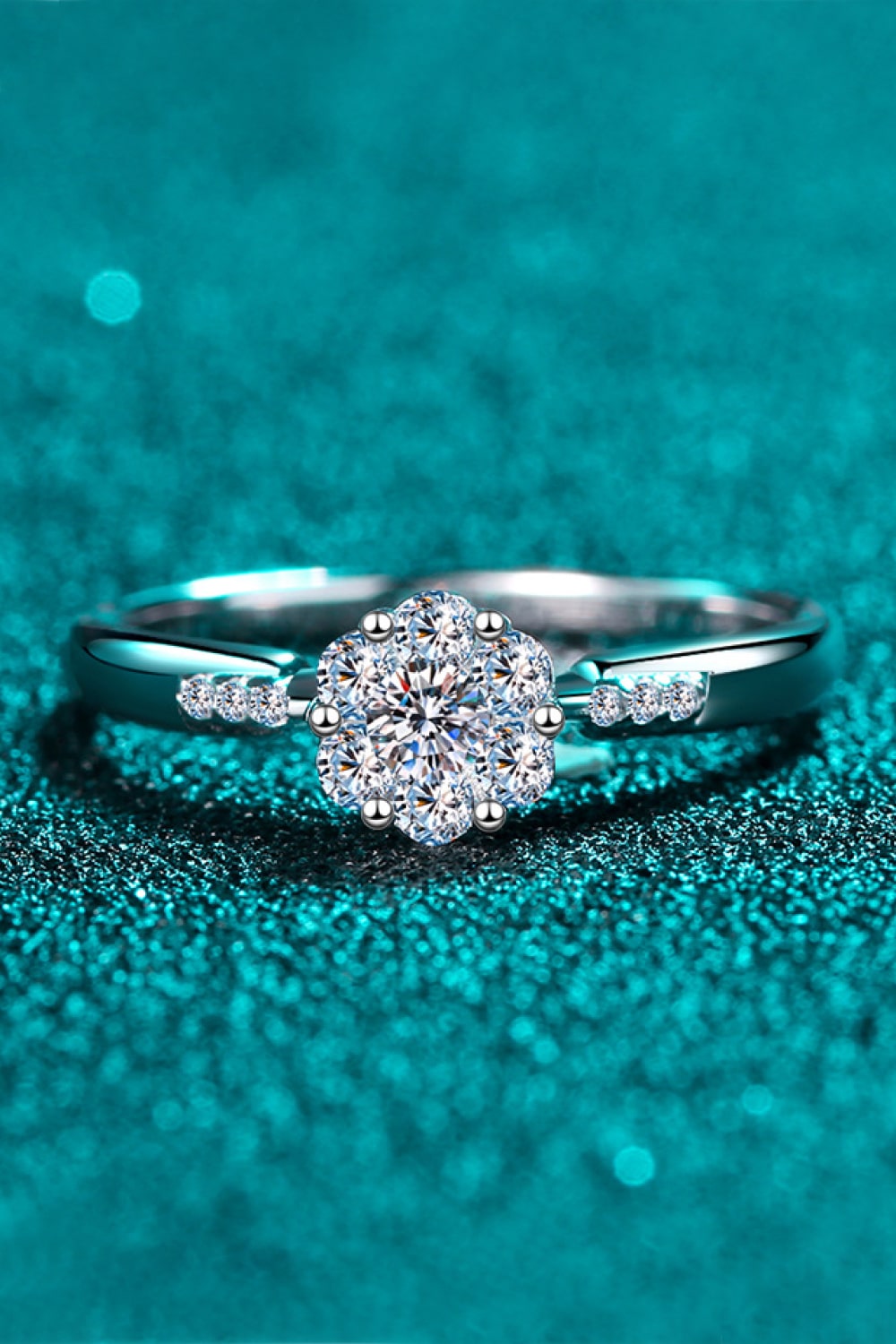 Silver engagement ring with floral cluster moissanite and accent stones.