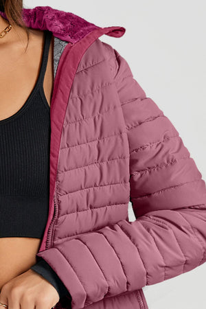 Quilted stand collar puffer jacket in Deep Purple with faux fur trim and a zippered front.