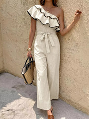 Elegant cream one-shoulder romper with ruffled trim and belted waist.