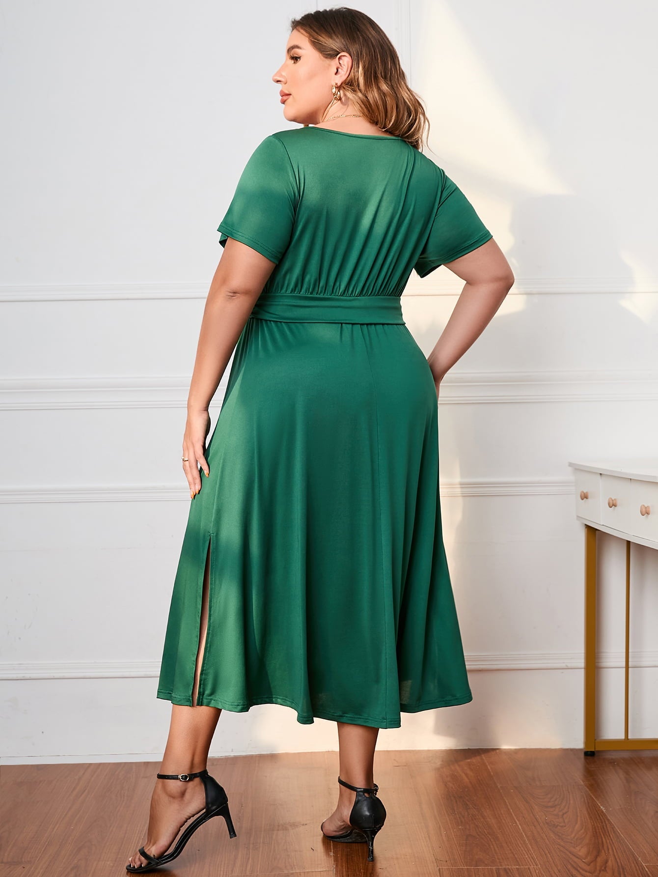 Emerald green polyester midi dress with short sleeves, V-neck, belted waist, and side slits.
