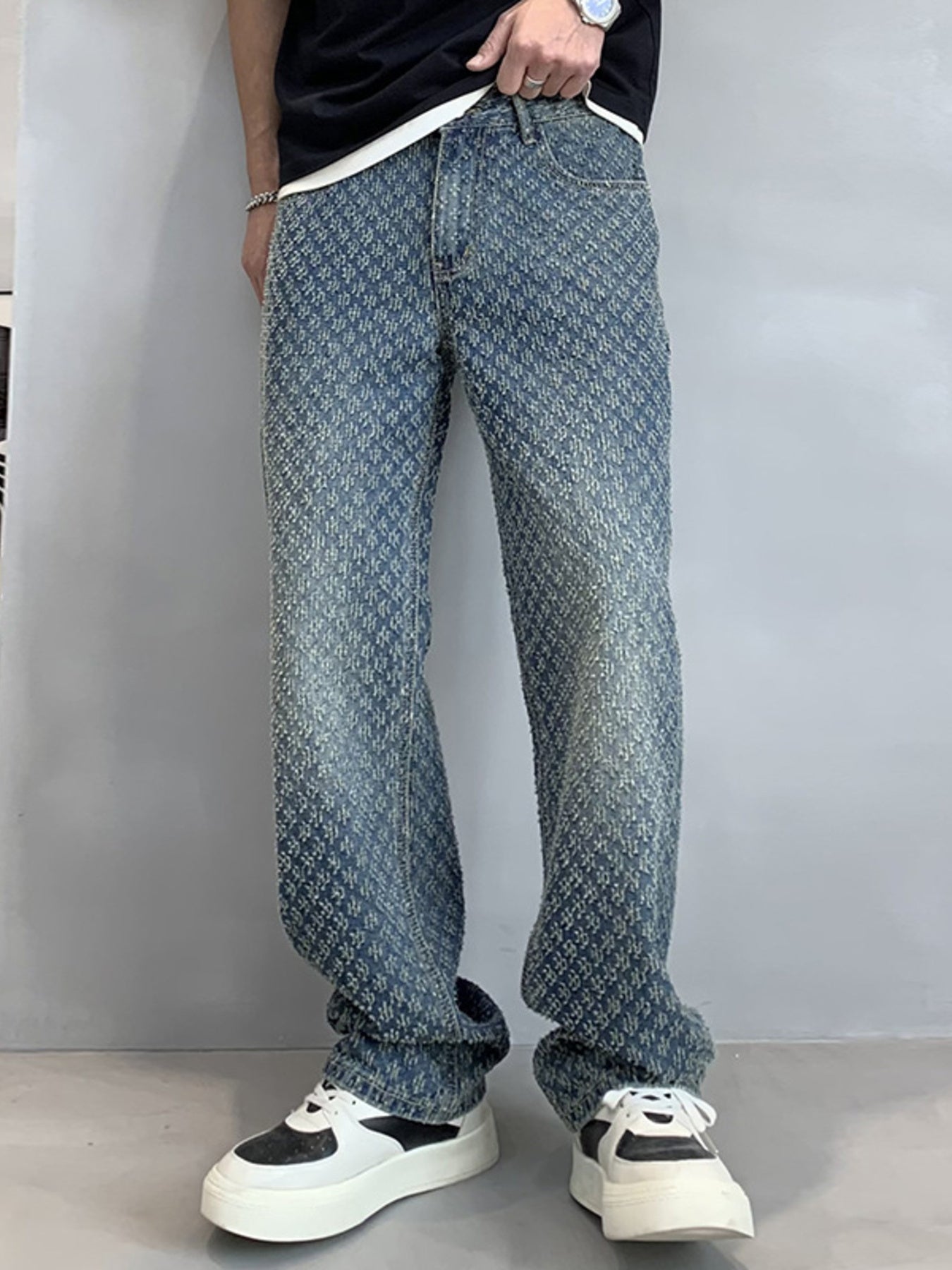 Relaxed fit blue denim jeans with allover textured pattern and vintage wash.