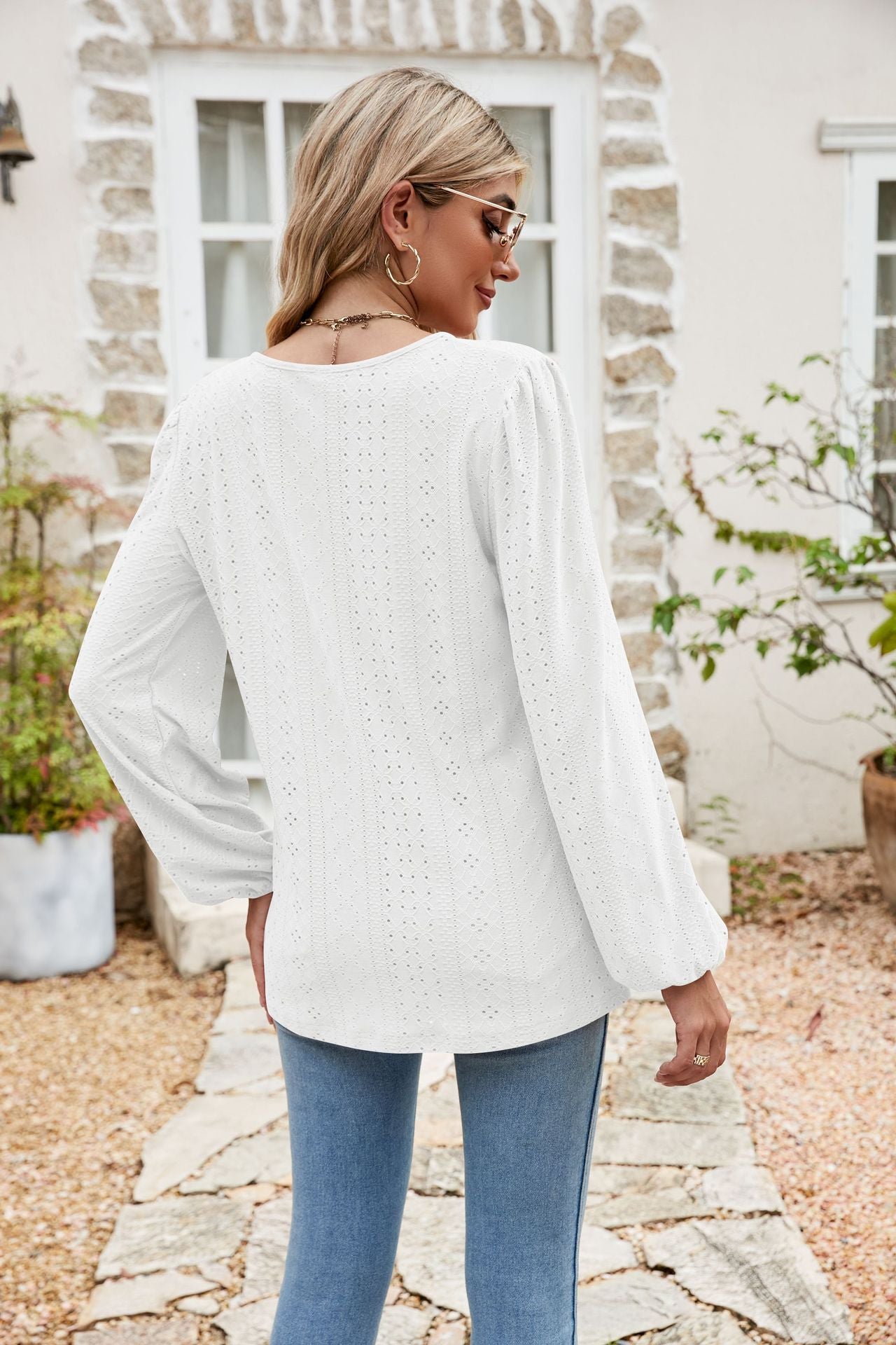 White eyelet yoke blouse with blouson sleeves and a textured pattern.
