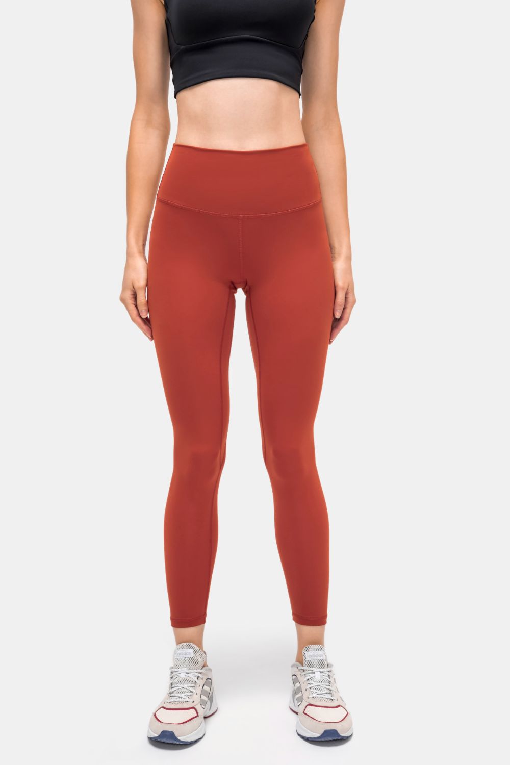 StealthFit pocketed leggings in Brick Red, high-waisted, full-length activewear pants.