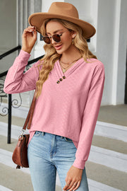 Textured pink henley v-neck top with button detail and long sleeves