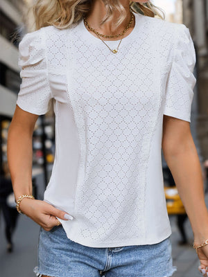 White eyelet panel puff sleeve blouse with lace trim detail.