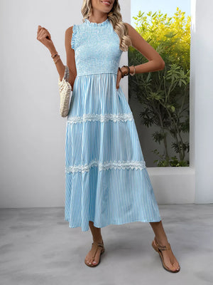 Blue striped sleeveless midi dress with smocked bodice and lace trim tiers.