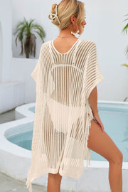 White open-knit beach cover-up with fringe detail and V-neck.
