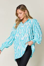 Zebra print blouse in Tiffany Blue with shirred cuffs and balloon sleeves.