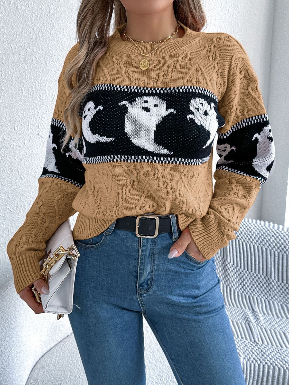 Camel cable knit crewneck sweater with ghost motif and long sleeves.