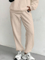 Tan cable knit lounge pants with textured detail, cuffed ankles.