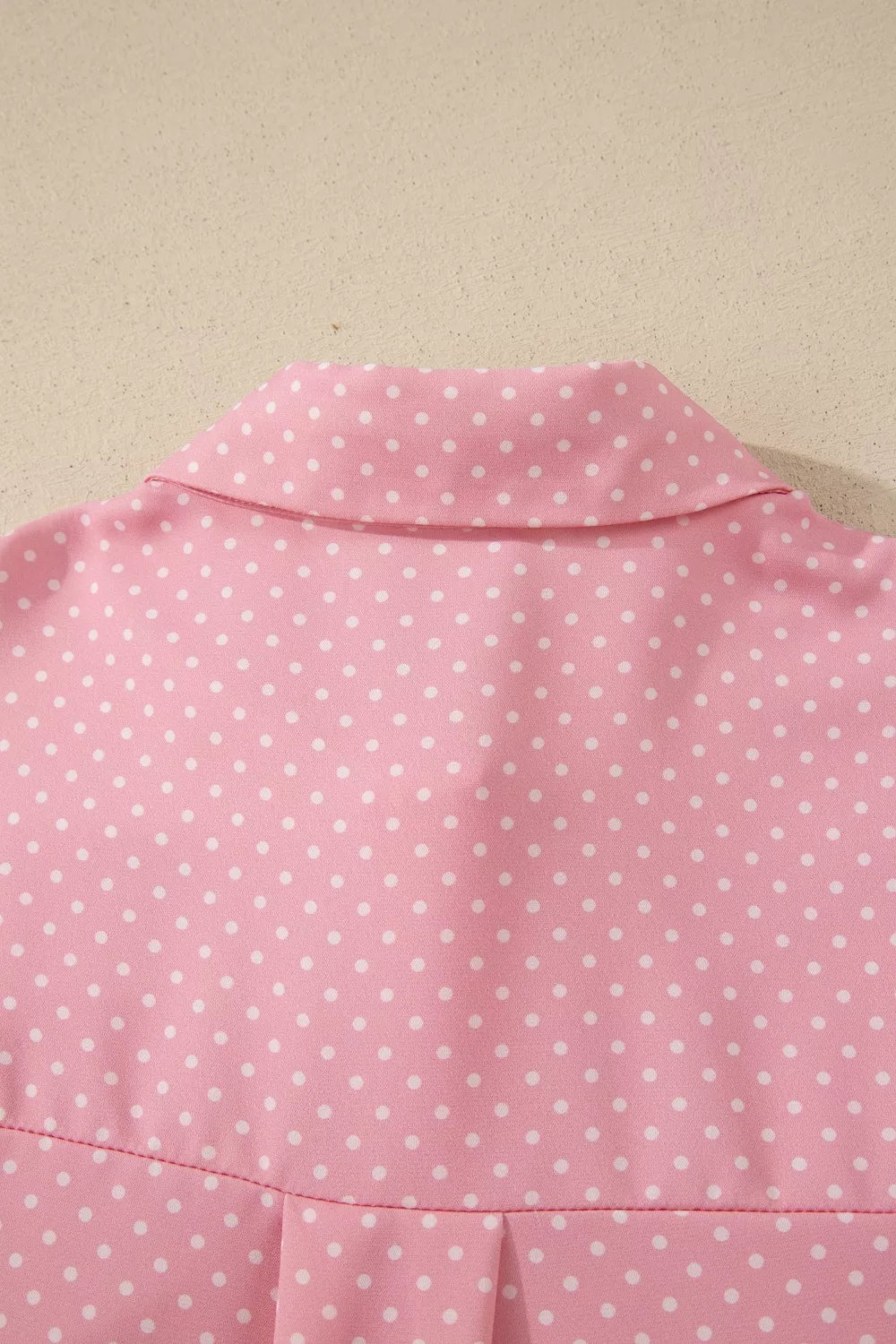 Pink polka dot print polyester button-up blouse with collar detail