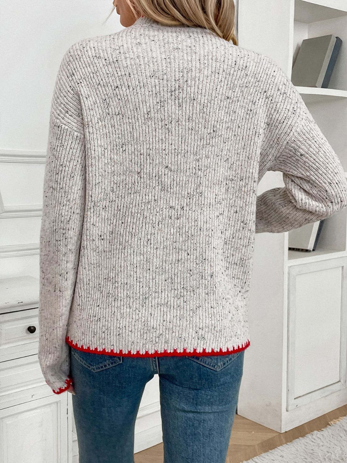 Light gray ribbed knit sweater with speckled detail and red trim