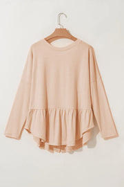 Peplum top in Dust Storm cotton with long sleeves and a ruffled hem.
