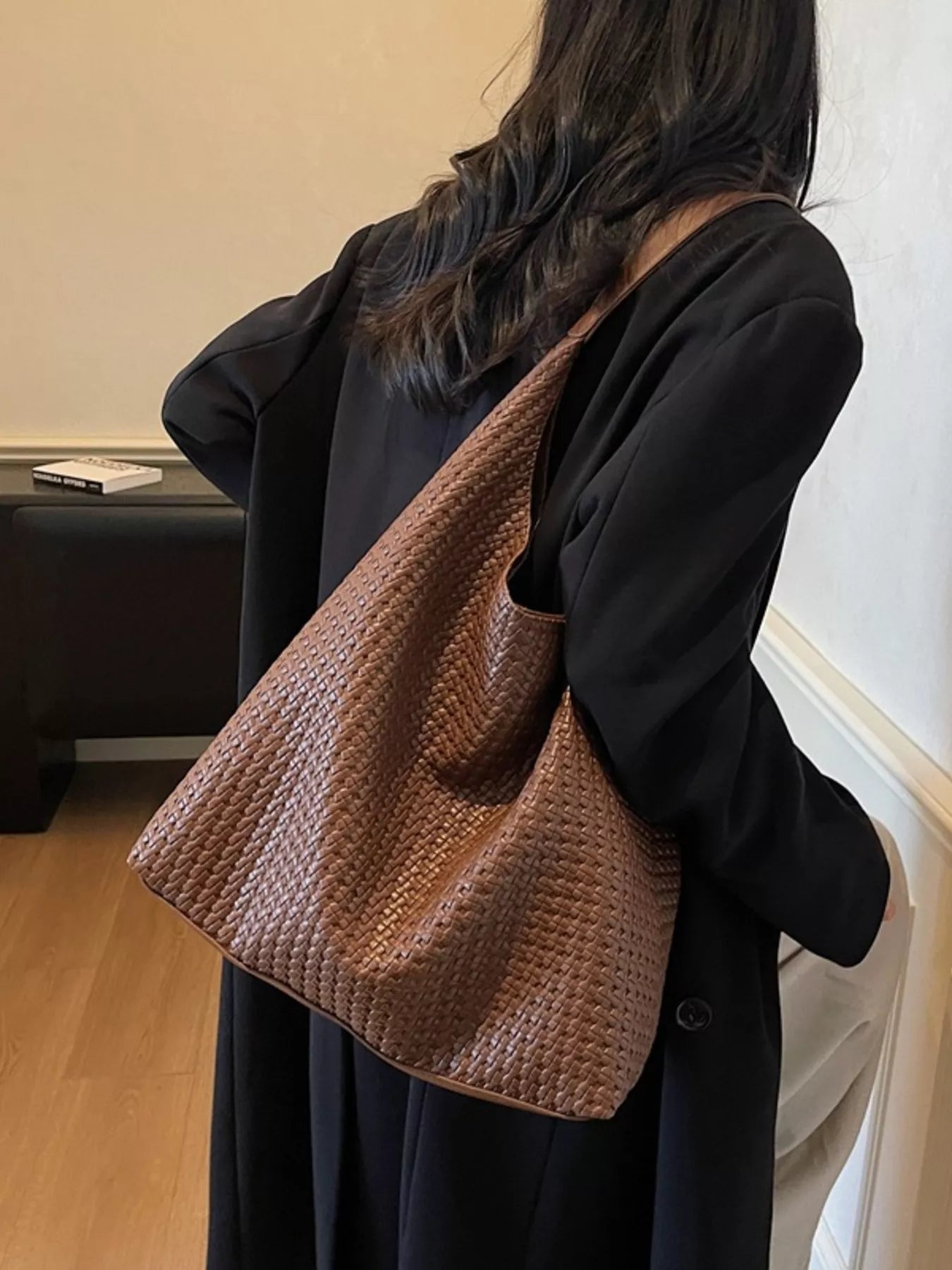 Brown woven straw texture tote bag with braided detail.