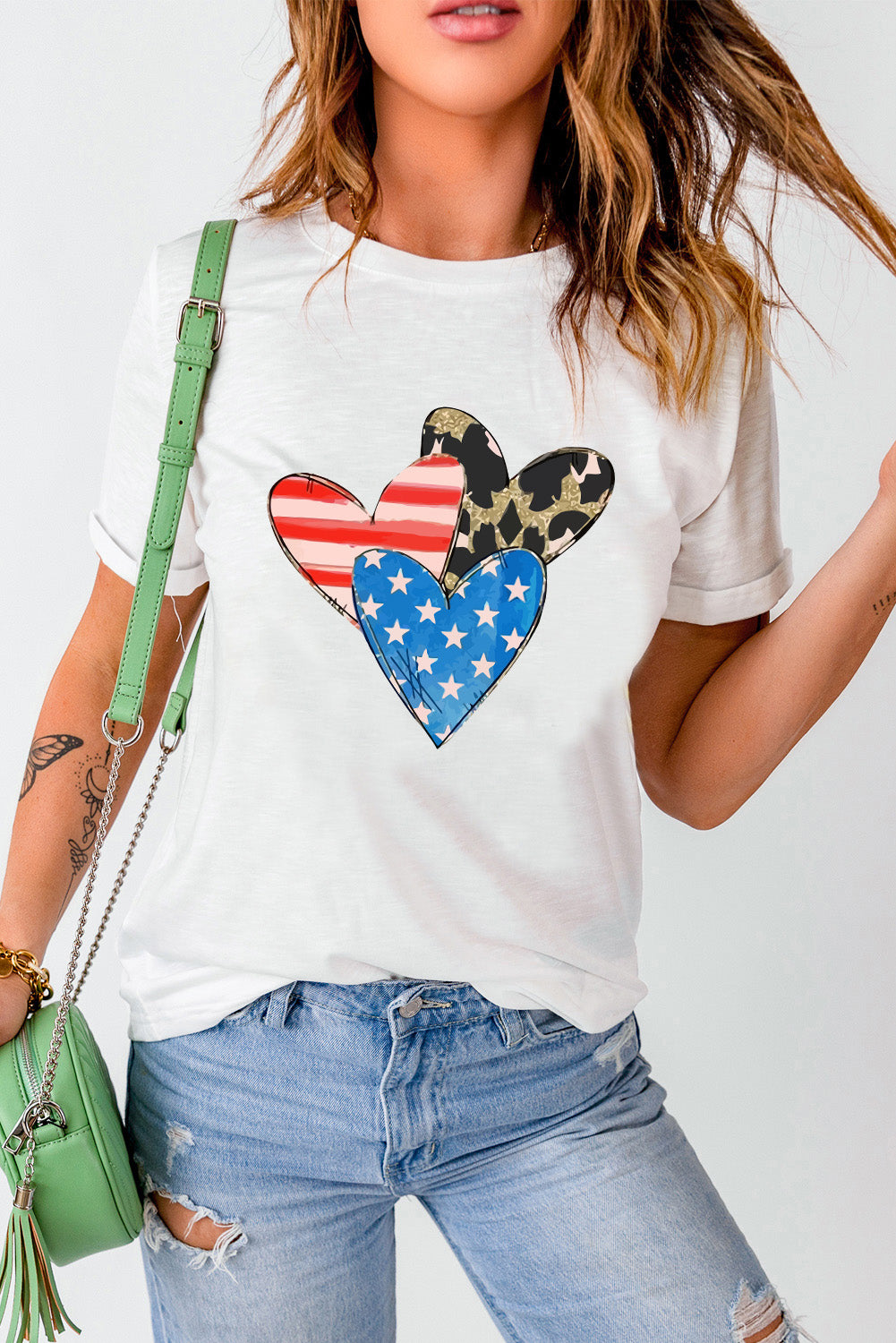 White graphic tee with American flag and leopard print hearts.