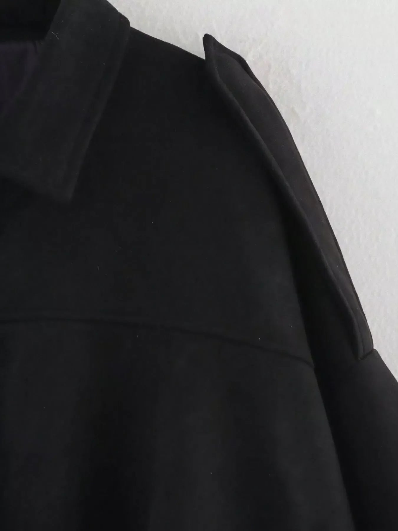 Black oversized zip-up jacket with a collar and shoulder detail
