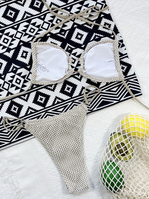 Ivory crochet halter bikini top with white cups and matching crochet bikini bottoms with ring detail.