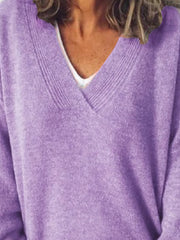 Relaxed lavender ribbed knit sweater with V-neck, layered over a white top.
