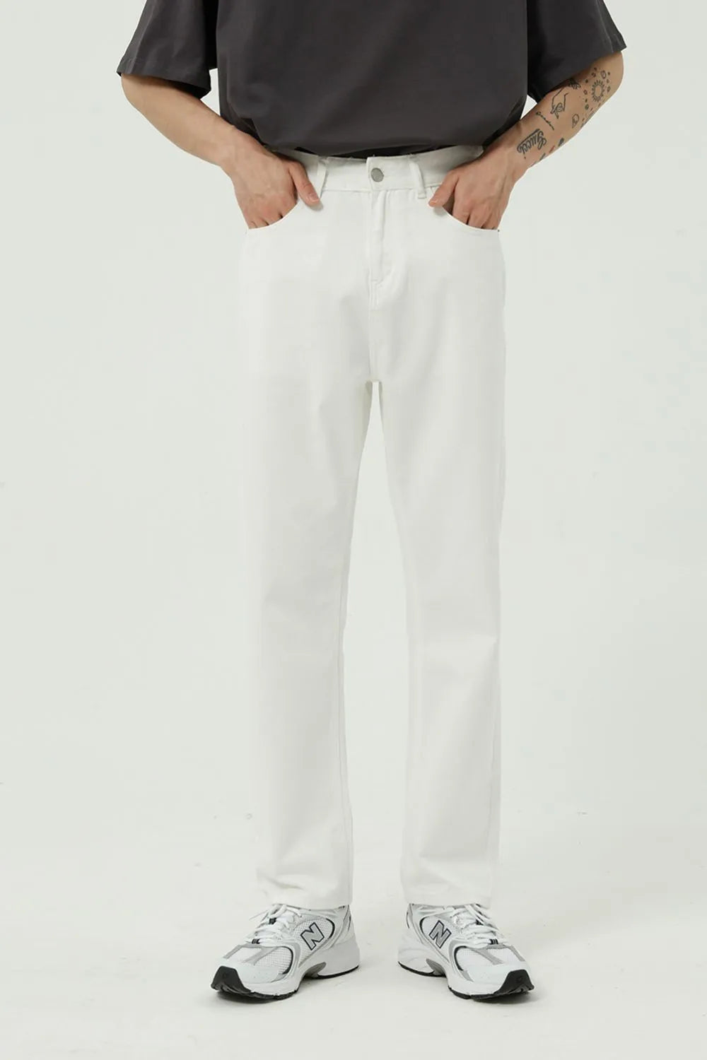 Relaxed fit ivory denim trousers with a straight leg and button fly.