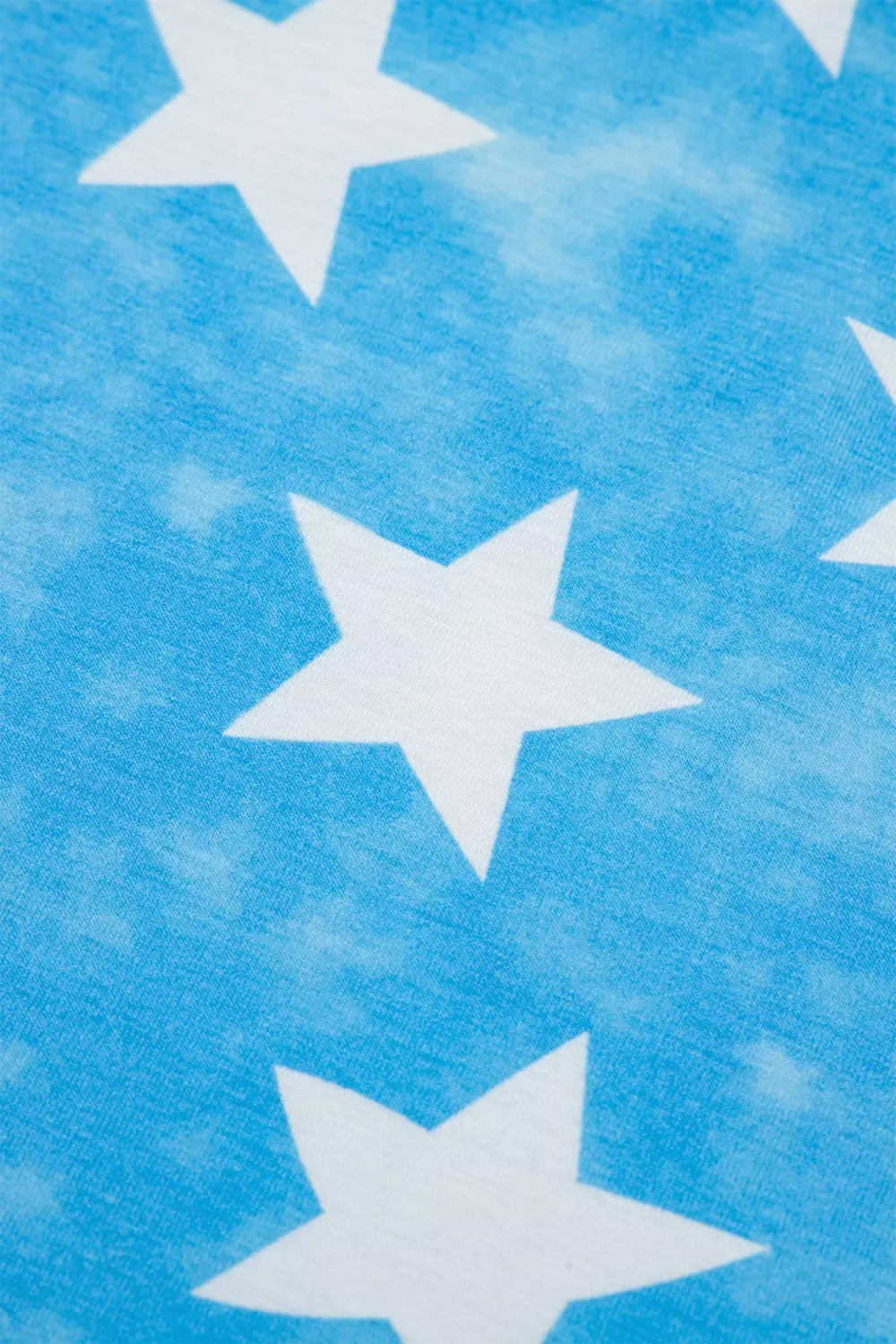 Patriotic t-shirt with white stars on a blue tie-dye background, short ruffle sleeves.