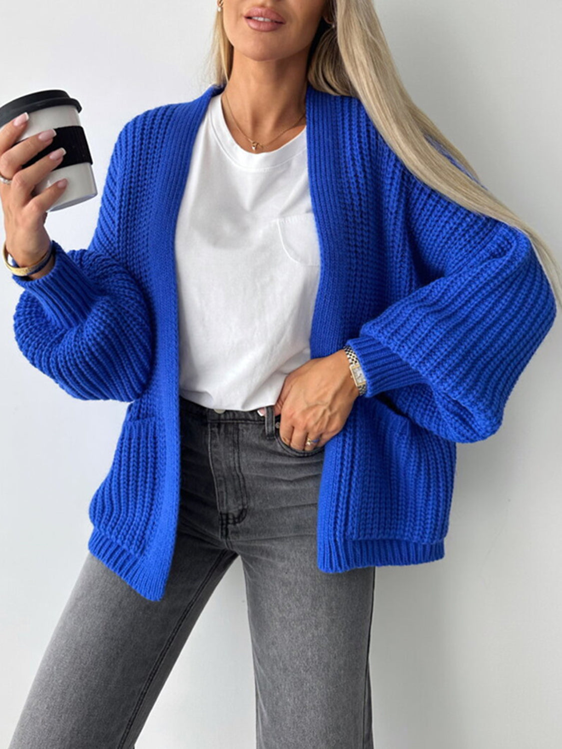 Textured puff sleeve cardigan in royal blue with ribbed knit and pockets.