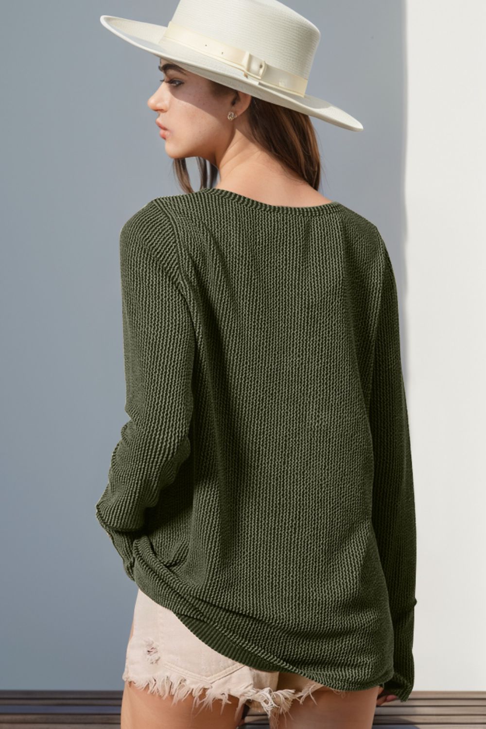 Moss green waffle knit henley shirt with thumbhole cuffs and a relaxed fit.