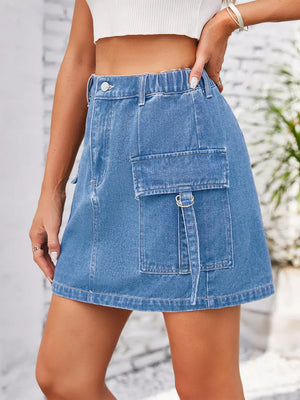 Denim cargo skirt in dusty blue with elastic waistband and utility pocket detail.