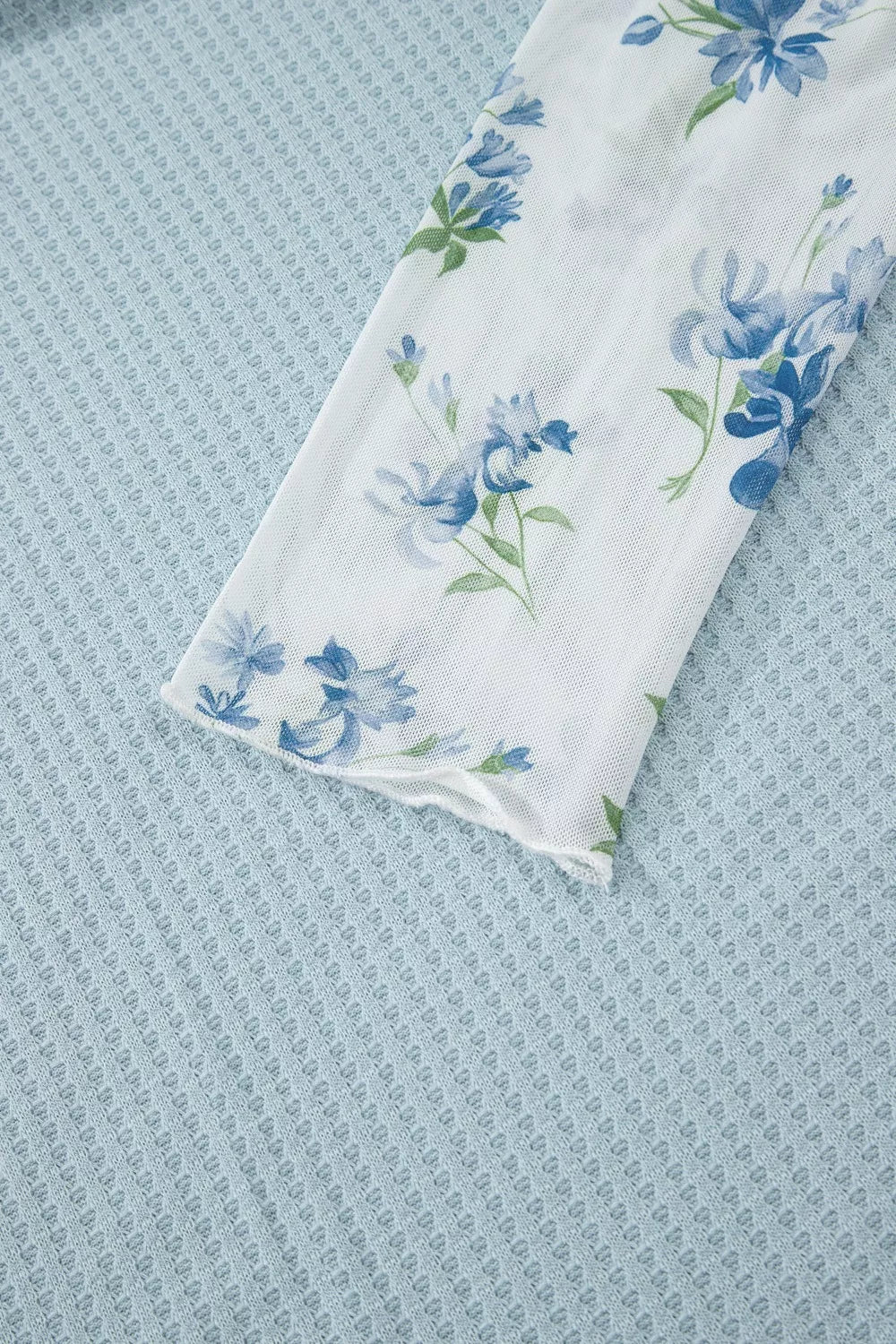 Floral lace sleeve mesh overshirt with blue floral print on white.