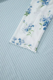 Floral lace sleeve mesh overshirt with blue floral print on white.