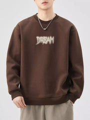 Brown crew-neck sweatshirt with "DREAM" graphic detail and ribbed cuffs and hem.