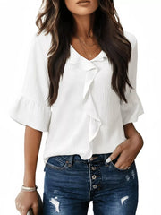 White maternity shirt with cascading ruffles and 3/4 bell sleeves.