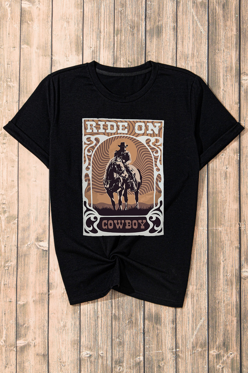 Black graphic t-shirt with a cowboy riding a horse and the words Ride On Cowboy.