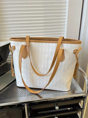 Textured diamond woven tote bag in white with tan straps and trim.
