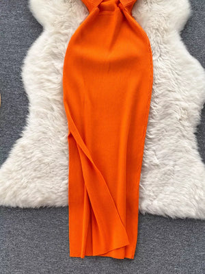 Orange ribbed knit midi dress with cutout back detail and side slit.