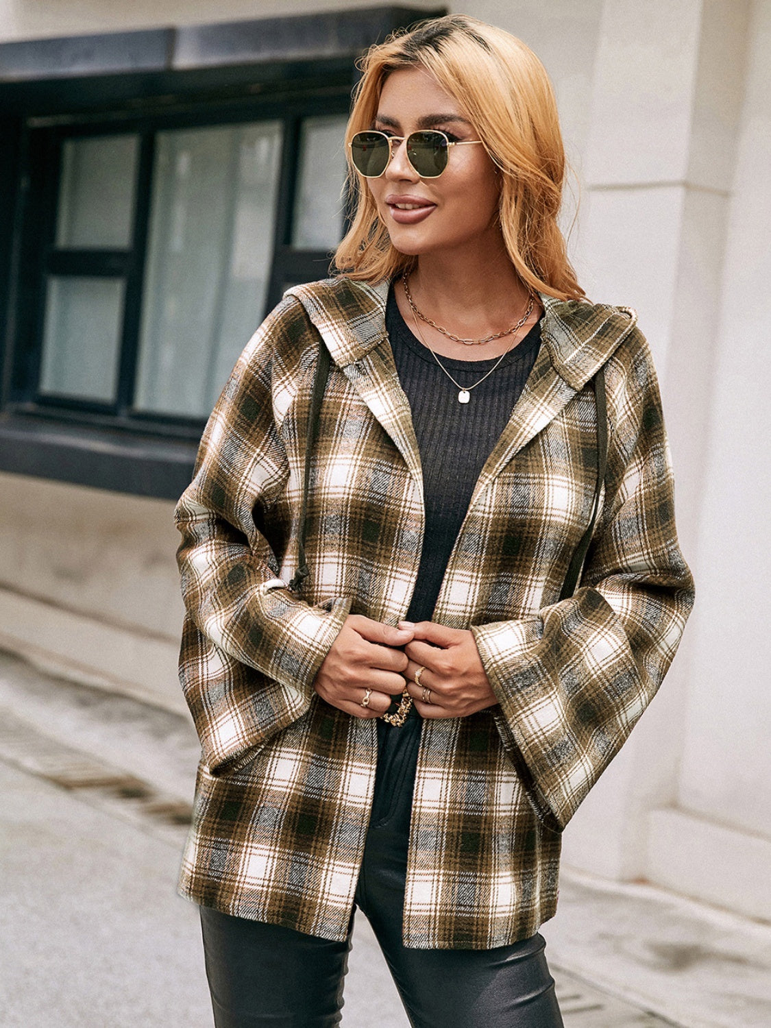 Flared sleeve hooded shacket in camel plaid with buttoned front detail.