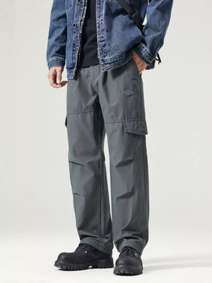 Dark gray utility cargo pants with oversized fit and large side pockets.