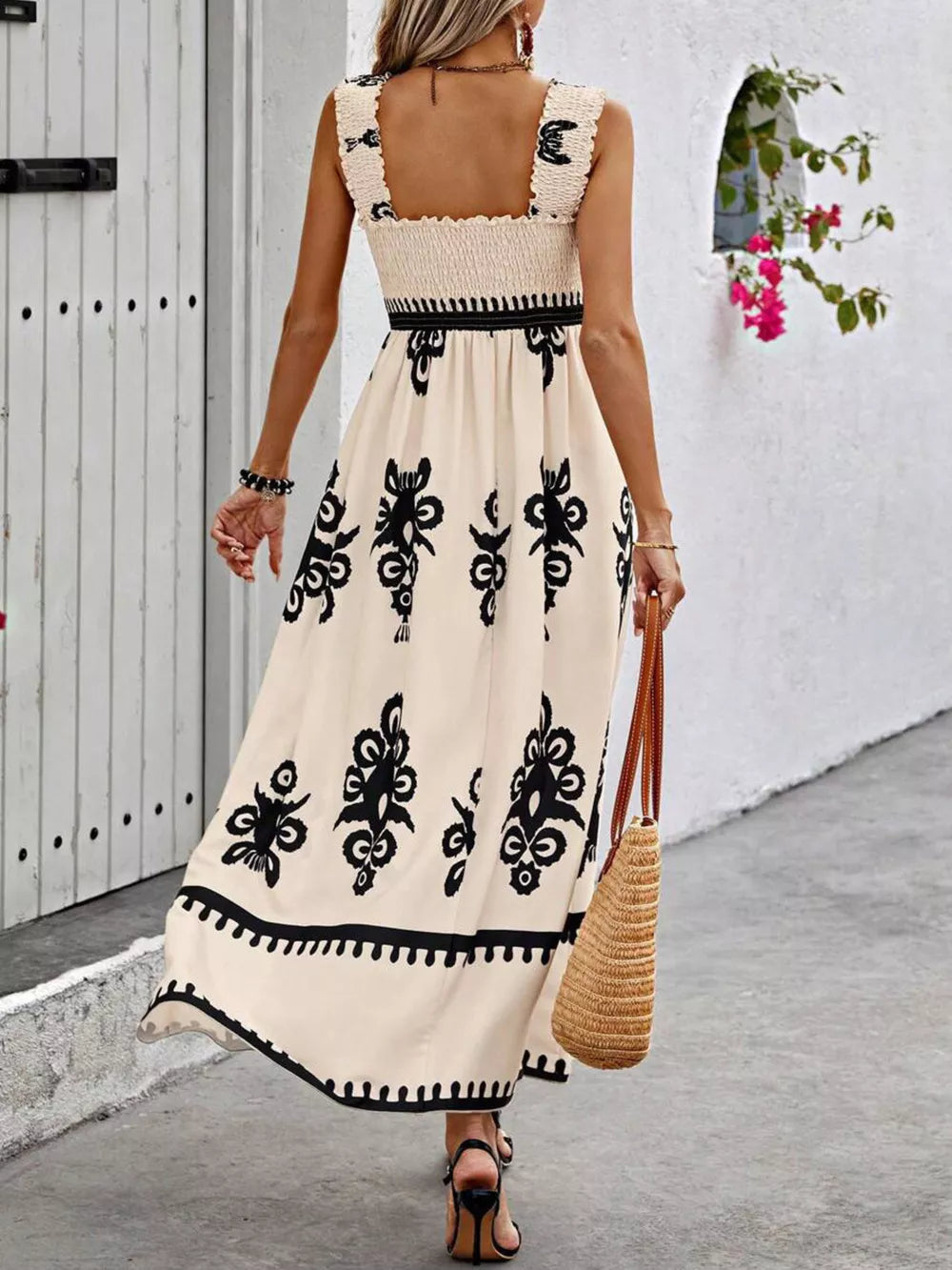Cream a-line maxi dress with black floral print, smocked bodice, and square neckline.