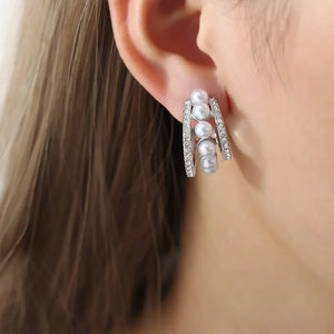 Silver double hoop earrings with pave details and four pearls.
