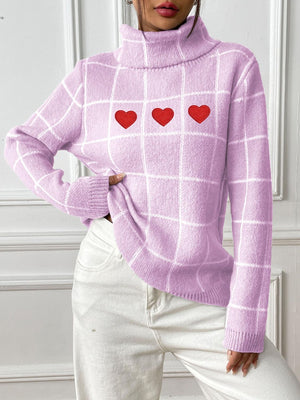 Pink purple gridwork turtleneck sweater with three red heart appliqués.