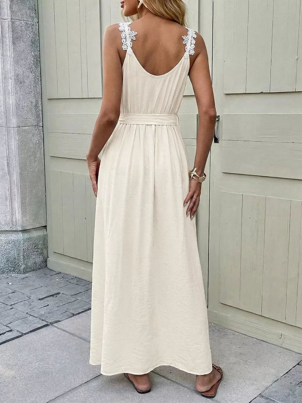 Beige lace-trimmed V-neck maxi dress with a belted waist and spaghetti straps.