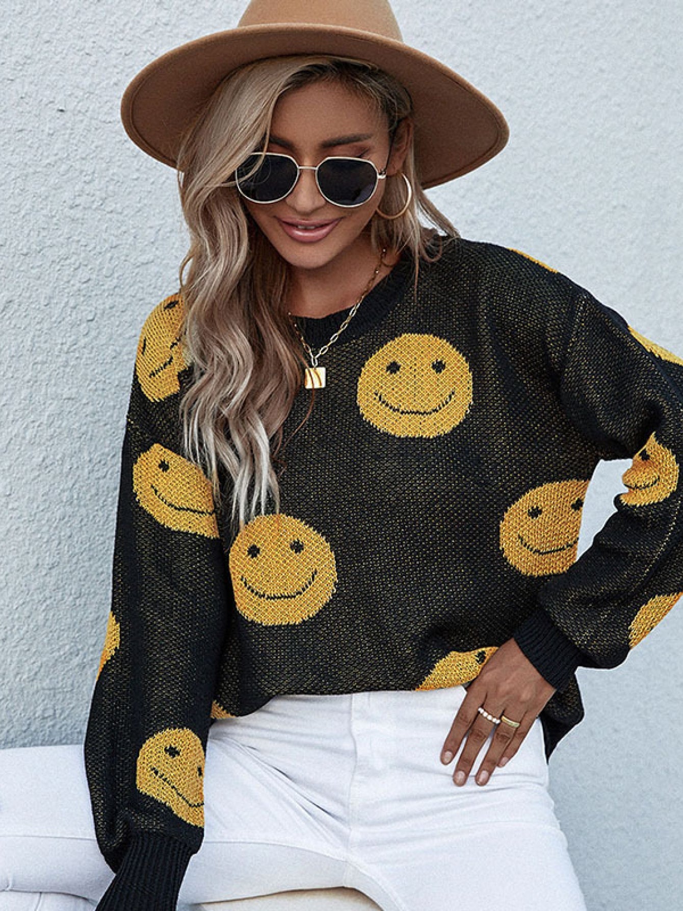 Black smiley face jacquard knit sweater with crewneck and long sleeves.