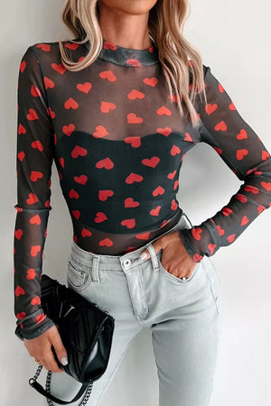 Black sheer mesh top with red heart print, long sleeves, and mock neck.