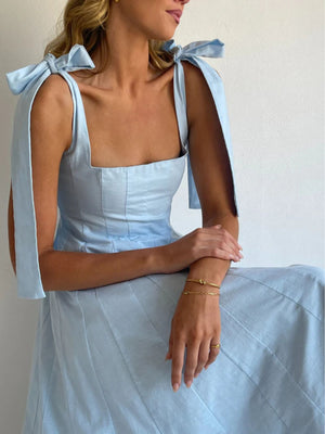 Light blue maxi dress with square neckline and bow tie shoulder straps.