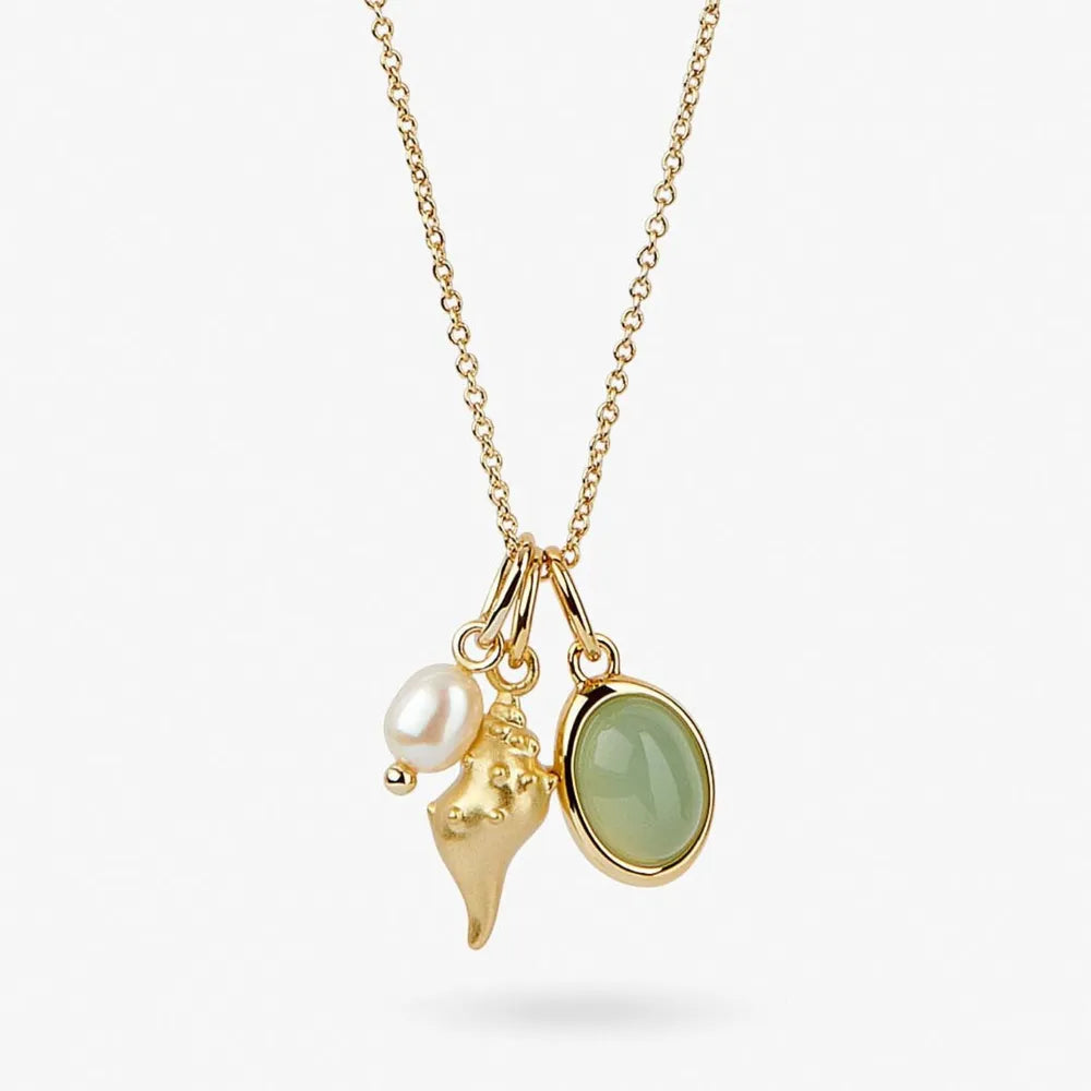 Gold necklace with seashell, pearl, and green gemstone charms